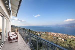 a balcony of a house with a view of the water at Villetta Olivi - Vista mozzafiato in Torri del Benaco