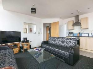 a living room with a couch and a glass table at City centre apartment with view in Manchester