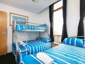 a room with two bunk beds and a window at City centre apartment with view in Manchester