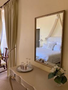 a bedroom with a bed and a large mirror at Faversham House in York