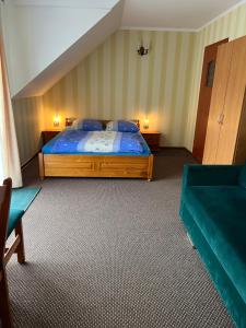 a bedroom with a bed and a couch at Baracuda in Dębki