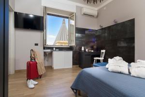 Televízia a/alebo spoločenská miestnosť v ubytovaní Il Tempio di Athena - Cultura e Relax a Siracusa