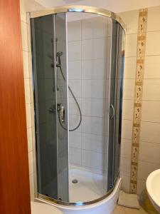 a shower with a glass door in a bathroom at Baracuda in Dębki