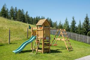 a wooden playground with a ladder and a slide at Berggasthof Höllenstein in Wagrain