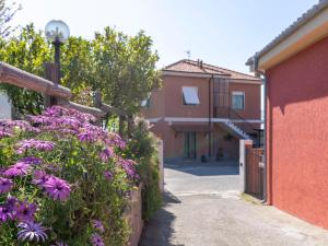 a garden with purple flowers next to a building at Apartment Carleadri by Interhome in Civezza