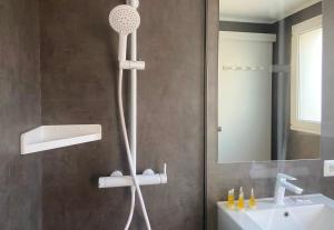 a shower in a bathroom with a sink at Carpe Diem Cadaqués in Cadaqués