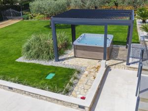a blue gazebo with a pool in a yard at Holiday Home Sara - KST251 by Interhome in Tar