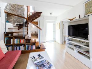 a living room with a tv and bookshelves at Holiday Home Le Mura by Interhome in Cividale del Friuli