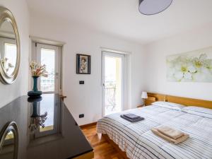 a white bedroom with a bed and a mirror at Holiday Home Le Mura by Interhome in Cividale del Friuli