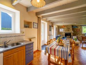 a kitchen and dining room with a table and chairs at Holiday Home Pen Ilis by Interhome in Saint-Jean-Trolimon