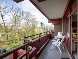 a balcony with two chairs and a table on it at Apartment B313 by Interhome in Lahnstein