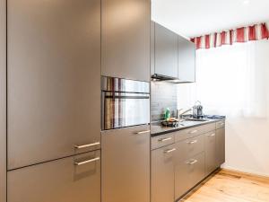 a kitchen with a large stainless steel refrigerator at Apartment TITLIS Resort Studio 1 by Interhome in Engelberg