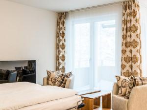 a bedroom with a bed and a window at Apartment TITLIS Resort Studio 1 by Interhome in Engelberg