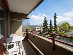 a balcony with a table and chairs and a view at Apartment A110 by Interhome in Lahnstein