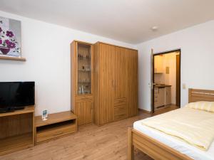 a bedroom with a bed and a flat screen tv at Apartment A110 by Interhome in Lahnstein