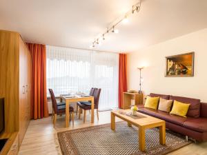 a living room with a couch and a table at Apartment A705 by Interhome in Lahnstein