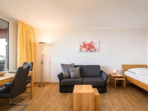 a hotel room with a bed and a couch and a table at Apartment B808 by Interhome in Lahnstein
