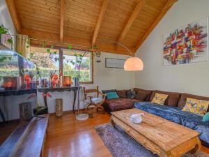 a living room with a couch and a table at Holiday Home Blue Moustoir by Interhome in Carnac