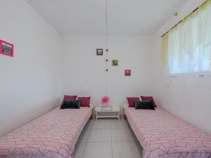 two beds sitting in a room with a window at Holiday Home Nautica-3 by Interhome in Le Barcarès