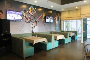 a dining room with two tables and two televisions at El Cielito Inn - Sta. Rosa in Santa Rosa
