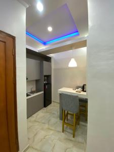 a kitchen with a table and a blue ceiling at Algara Puncak Hotel in Puncak