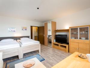 een slaapkamer met een bed en een tv in een kamer bij Apartment B306-B307 by Interhome in Lahnstein
