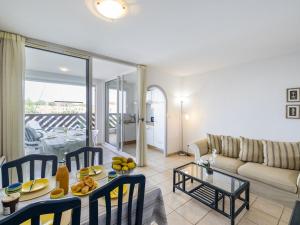 ein Wohnzimmer mit einem Tisch und einem Sofa in der Unterkunft Apartment Les Quais de L'Amirauté-8 by Interhome in Saint Cyprien Plage