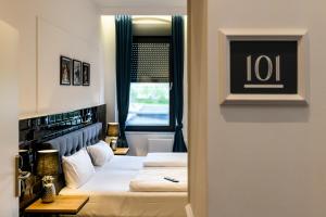 a hotel room with two beds and a window at Nikii Boutique Hotel in Leverkusen