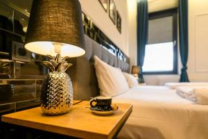 um quarto de hotel com uma cama e uma mesa com um candeeiro em Nikii Boutique Hotel em Leverkusen