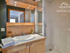 a bathroom with a sink and a shower and a mirror at Appartement Le Grand-Bornand, 5 pièces, 8 personnes - FR-1-391-94 in Le Grand-Bornand