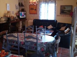 a living room with a table and a couch at Appartement Prats-de-Mollo-la-Preste, 3 pièces, 6 personnes - FR-1-659-60 in Prats-de-Mollo-la-Preste