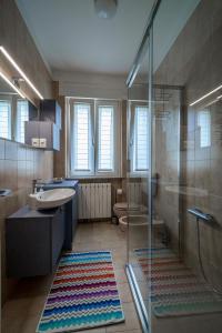 a bathroom with a glass shower and a sink at Casa Vacanza Acqua Dolce in Maccagno Inferiore