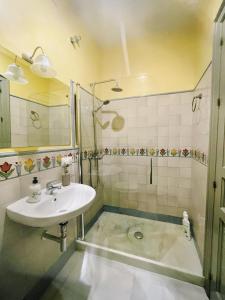 a bathroom with a sink and a shower at Carmona Center Apartment in Carmona