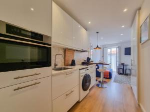 a kitchen with a sink and a washing machine at SAM - Studio in the city center in Viana do Castelo