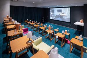 a restaurant with tables and chairs and a projection screen at Studio One Hotel in Dubai