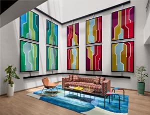 a living room with a couch and colorful windows at Ginger Chennai OMR in Chennai