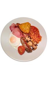 a plate of food with eggs bacon beans and toast at Newcastle House Rothbury in Rothbury