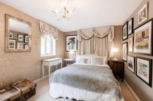 a bedroom with a bed and a table and a mirror at Orchard Paddocks in Guildford