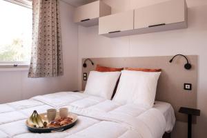 a bedroom with a bed with a bowl of fruit on it at L'Orée de l'Océan - Vendée in Landevieille