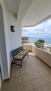 a bench on a balcony with a view of the ocean at Moraira Beach in Moraira
