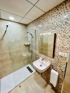 a bathroom with a sink and a shower at Tortosa Parc in Tortosa