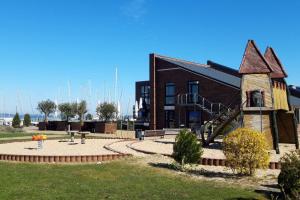 ein Gebäude mit einem Spielplatz davor in der Unterkunft Strandmöwe in Laboe