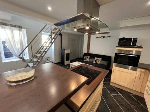 a kitchen with a counter top and a stove top oven at Opale YourHostHelper in Luc-sur-Mer