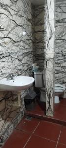 a bathroom with a sink and a toilet at H2Homestay phố cổ check in tự động in Hanoi