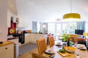 cocina y comedor con mesa y sillas en Bosinver Farm Cottages Well Close en St Austell