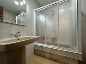 a bathroom with a sink and a glass shower at Oktheway Et Suseia in Sarria +24 photos