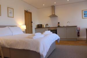 a bedroom with a bed with towels on it at Pike O'Stickle in Bowness-on-Windermere