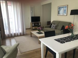 un salon avec un canapé et une table dans l'établissement Kaiservillen Heringsdorf - Ferienwohnung mit 1 Schlafzimmer und Balkon D221, à Heringsdorf