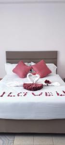 a bed with red and white flowers on it at Mataman Gardens in Naivasha