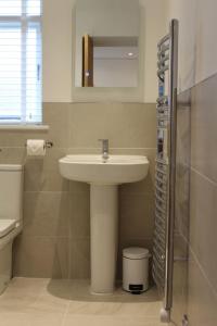 a bathroom with a sink and a mirror at Pike O'Stickle in Bowness-on-Windermere
